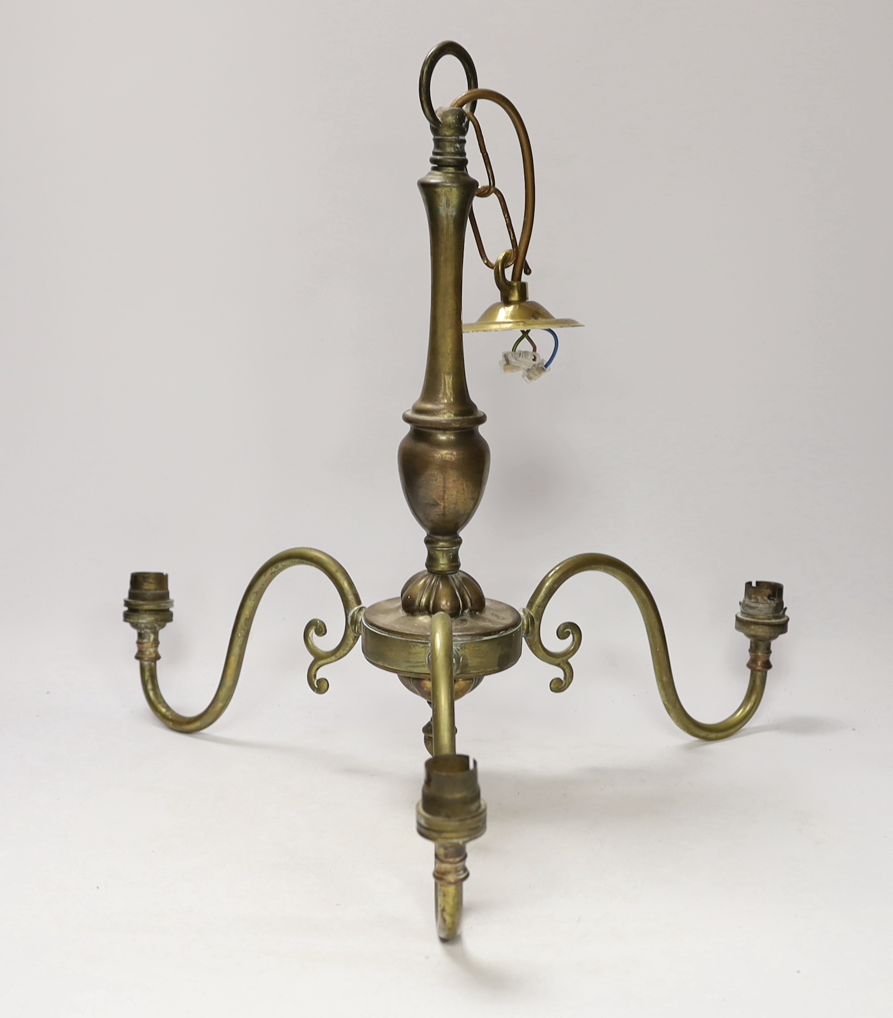 Three brass desk lamps and a three-branch electrolier together with a brass-mounted ceiling light with clear glass shade largest overall 53cm high (5)